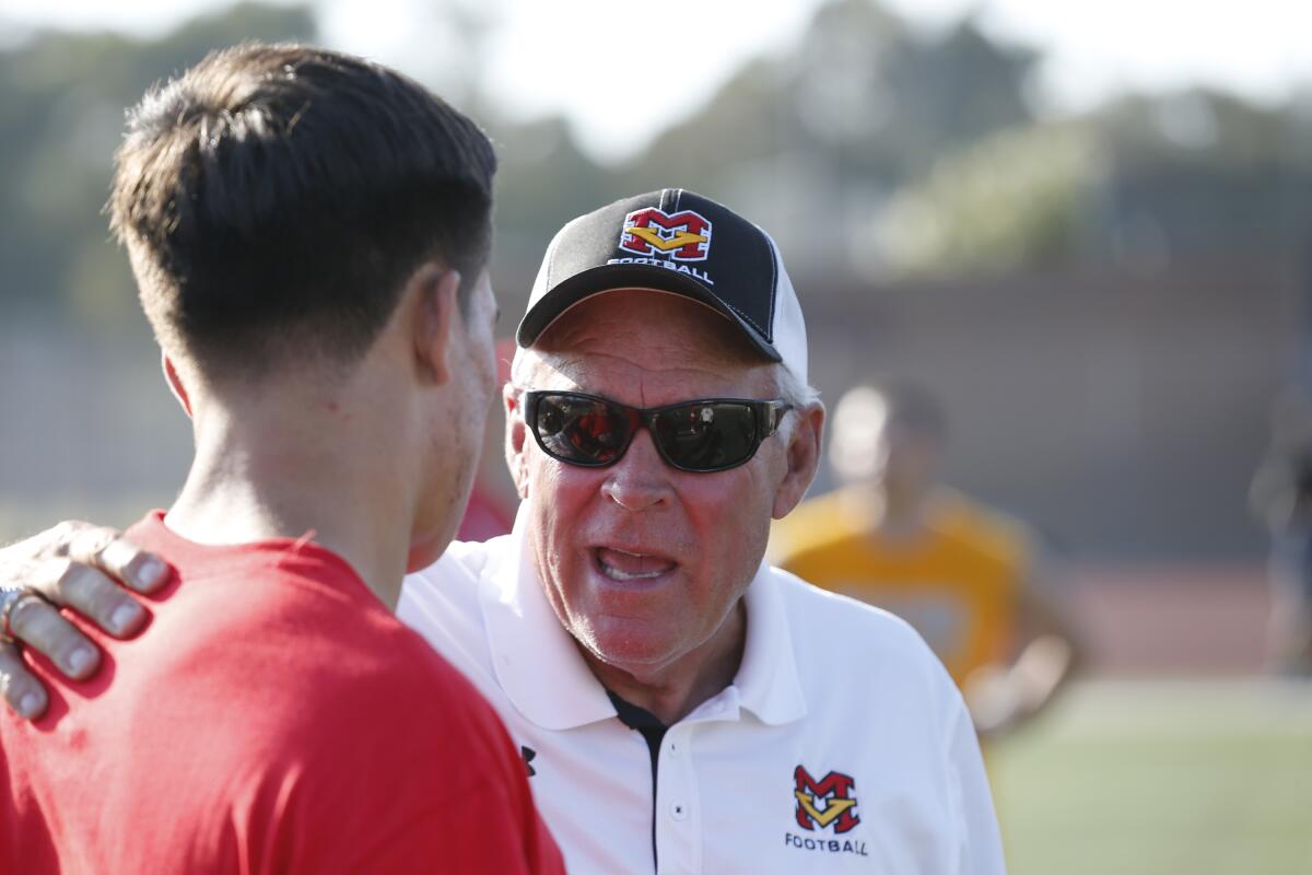 Coach Bob Johnson mentoring a player at practice